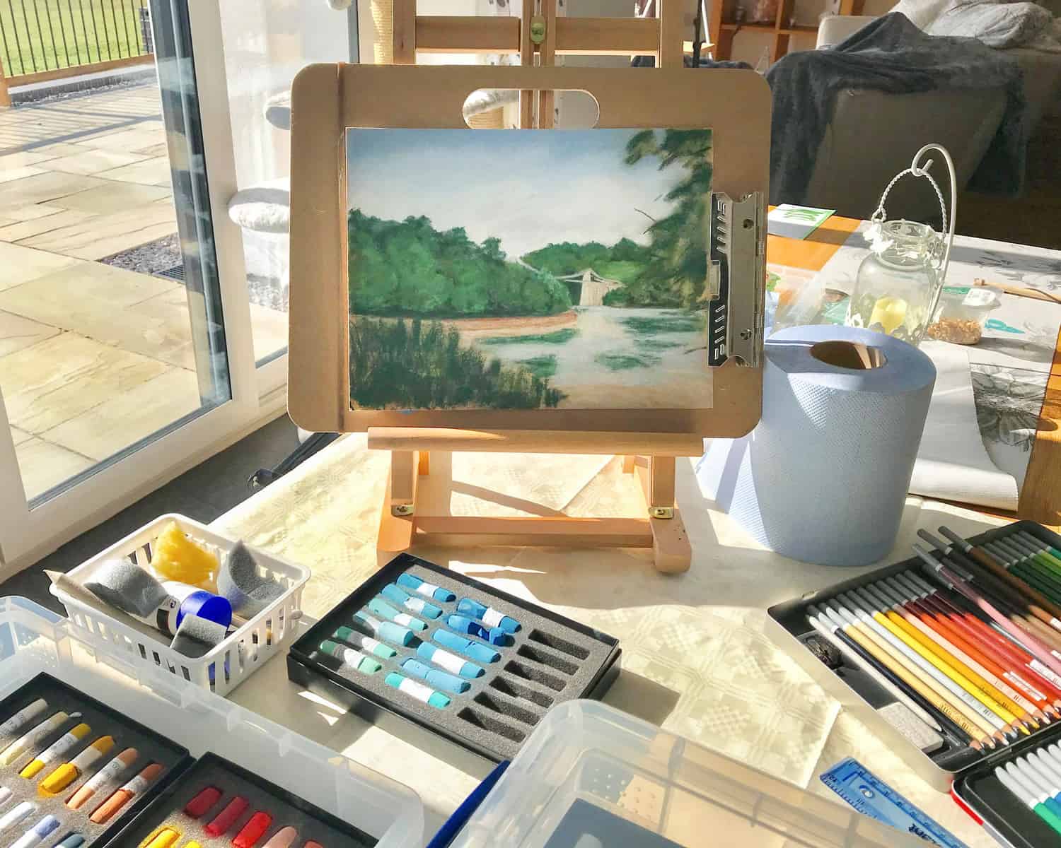 Art Just by Joan Artist Studio with paints and easel
